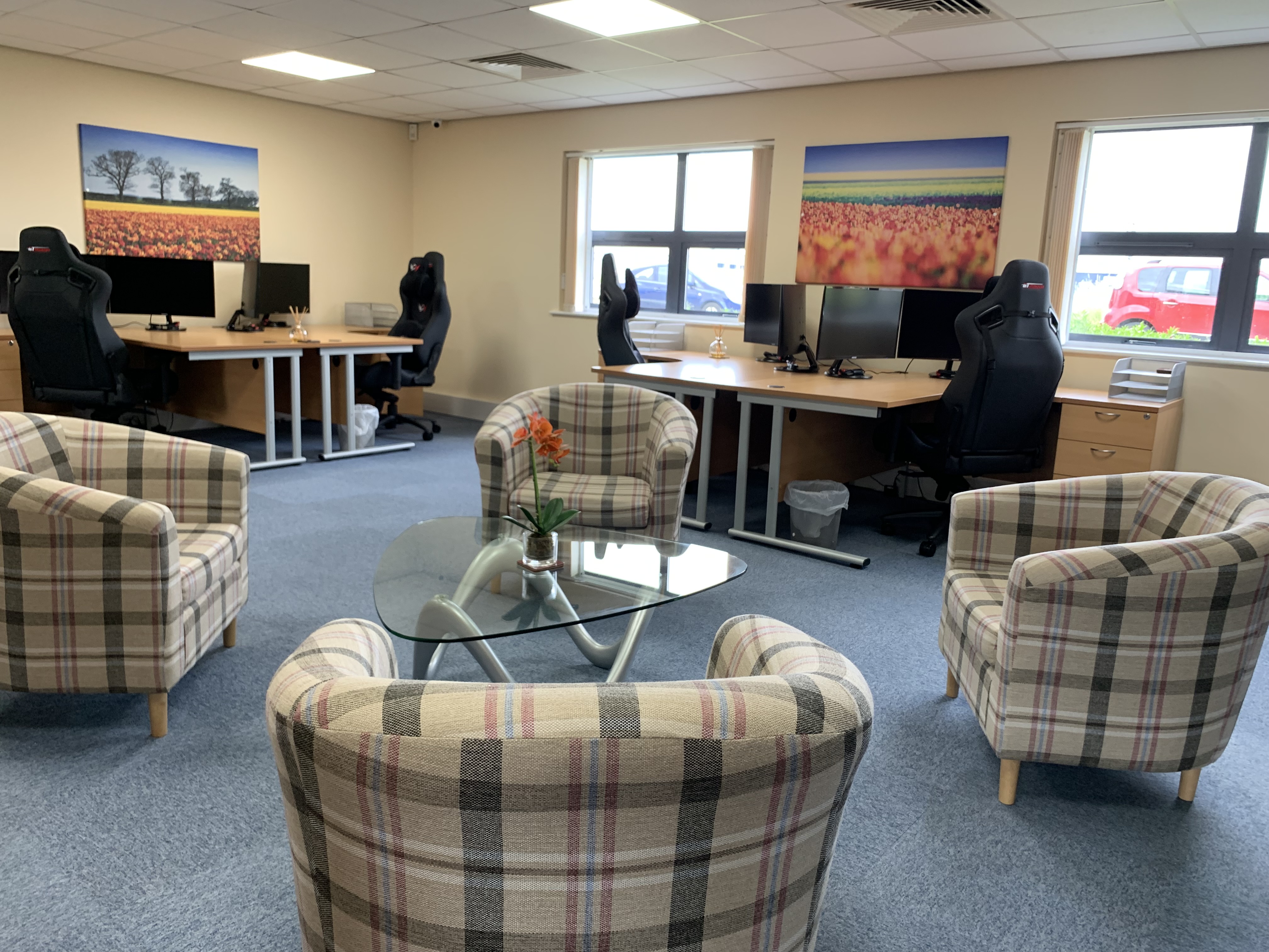 Colourful Digital transformation suite with multiple desks and screens in a colourful office