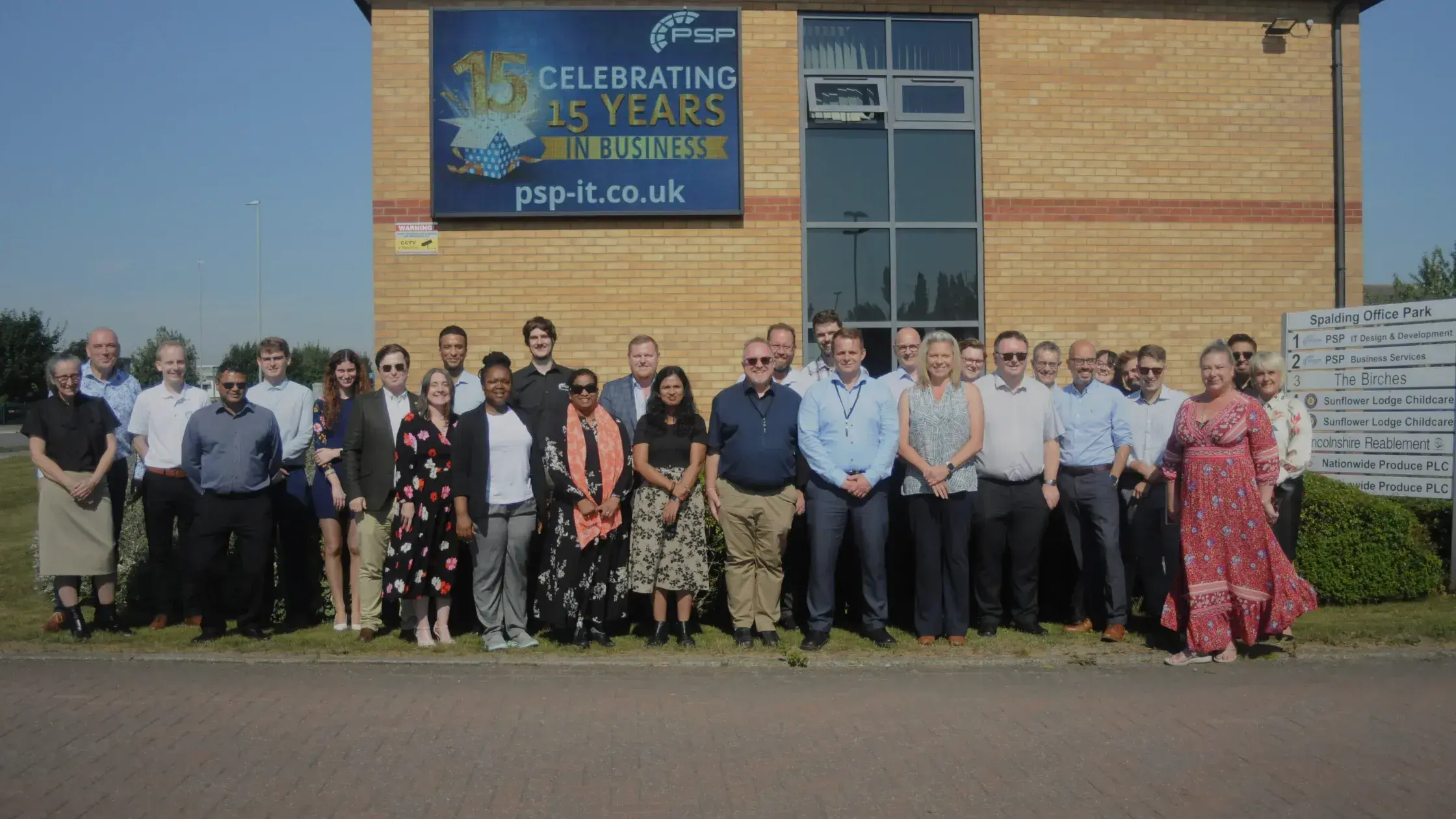 PSP IT team celebrating 15th anniversary in front of office